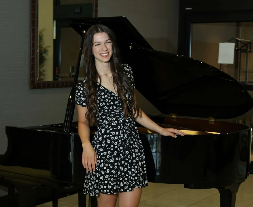 Girl standing before a piano